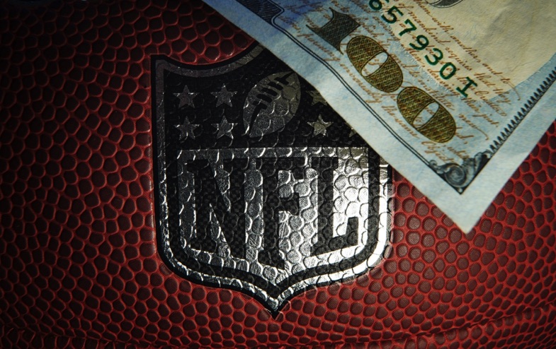 NFL logo on football with money