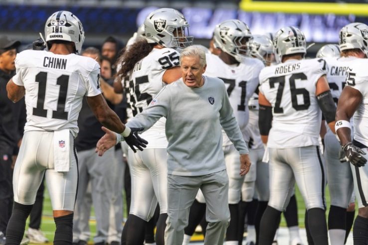 Pete Carroll, head coach, shaking hands with his players